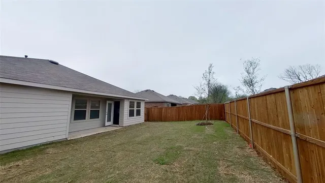 a view of a house with a backyard