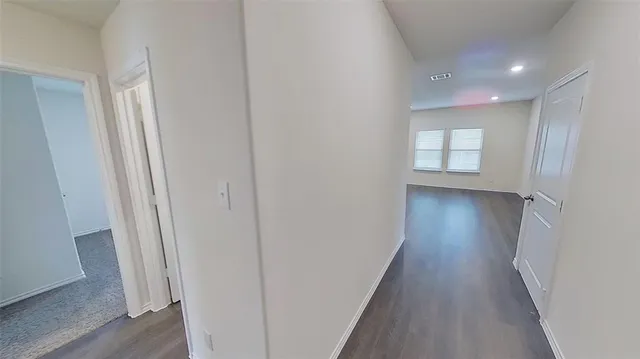 a view of hallway with wooden floor