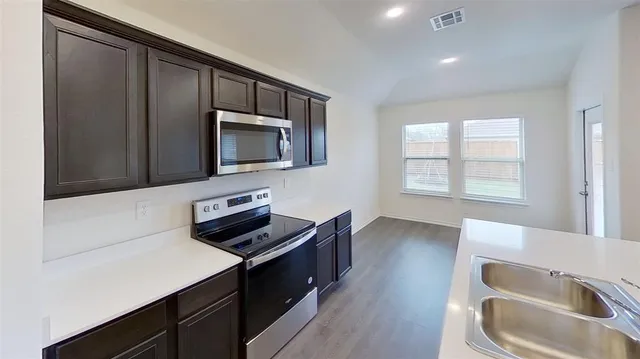 a kitchen with a sink and a microwave