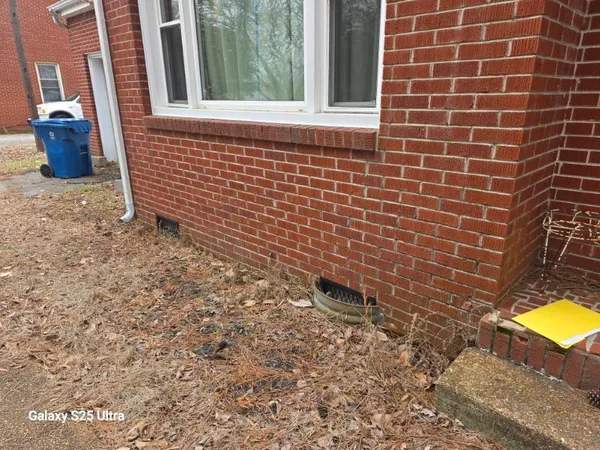 a view of a brick wall and a window