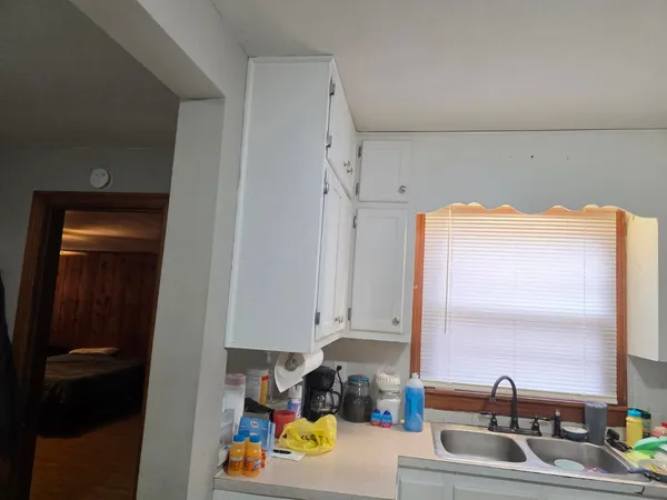 a kitchen with a stove and white cabinets