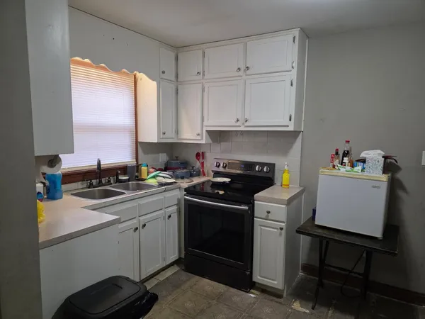 a kitchen with a sink and cabinets