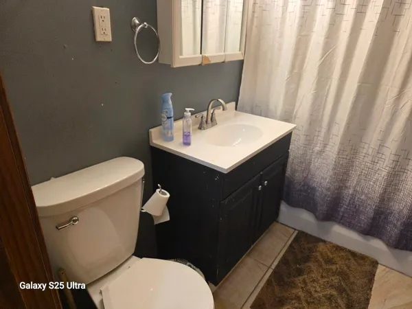 a bathroom with a shower curtain and a curtain