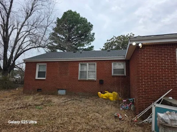 a brick building with a tree