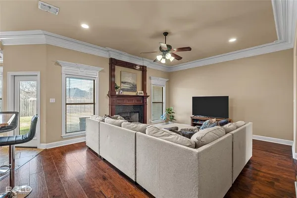 a kitchen with granite countertop a sink a center island a stove and a wooden floor