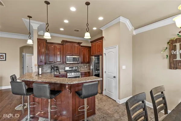 a bedroom with a bed and a flat tv screen on dresser