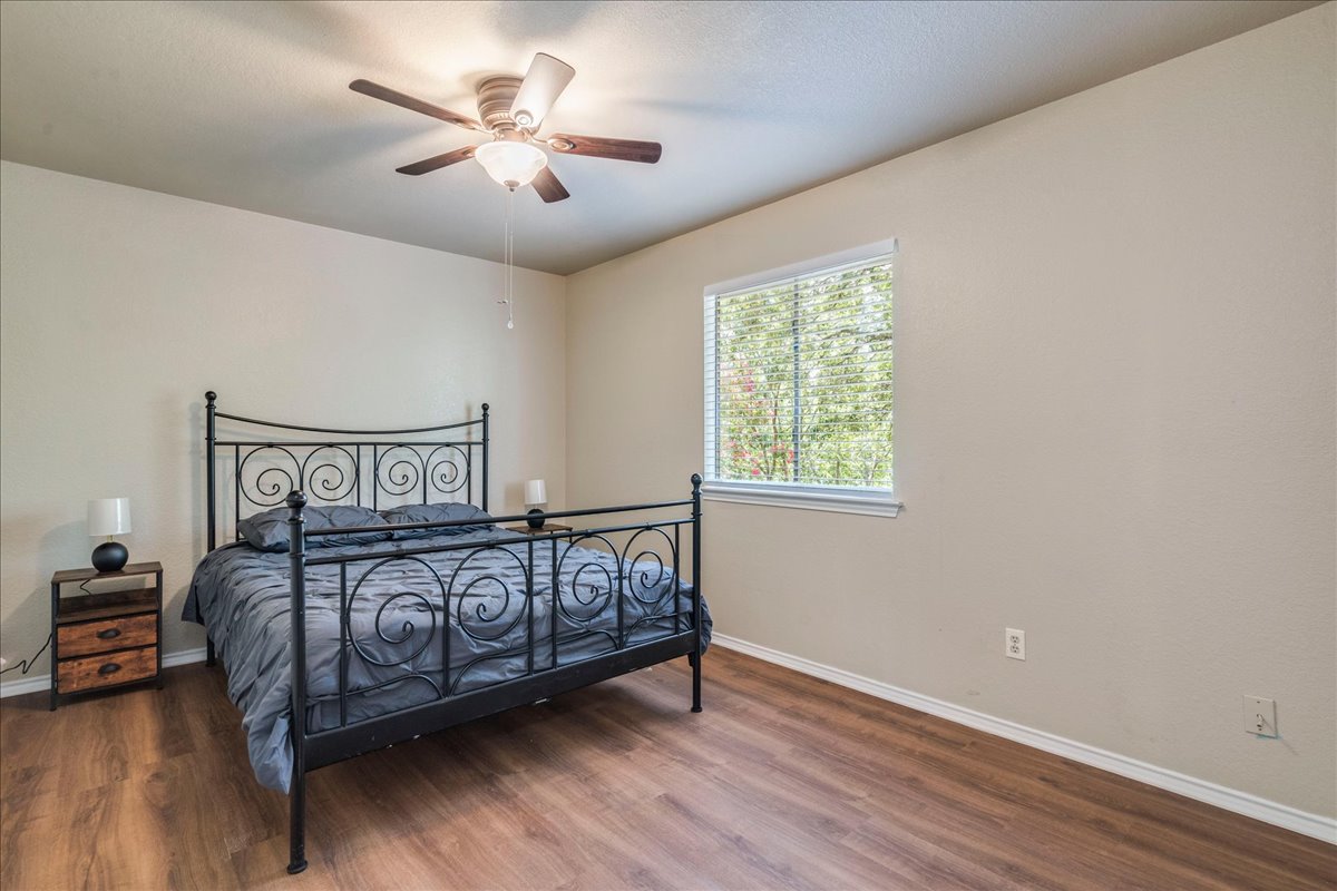 9300 Tea Rose Trail Austin, TX 78748 - Photo 23 of 33 Well-lit sleeping quarters with rich hardwood flooring.
