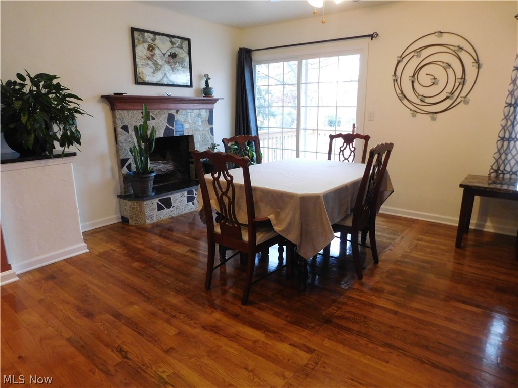 1693 Betz Road Akron, OH 44306 - Photo 21 of 29 Dining room with granite fireplace and patio doors leading out to a deck
