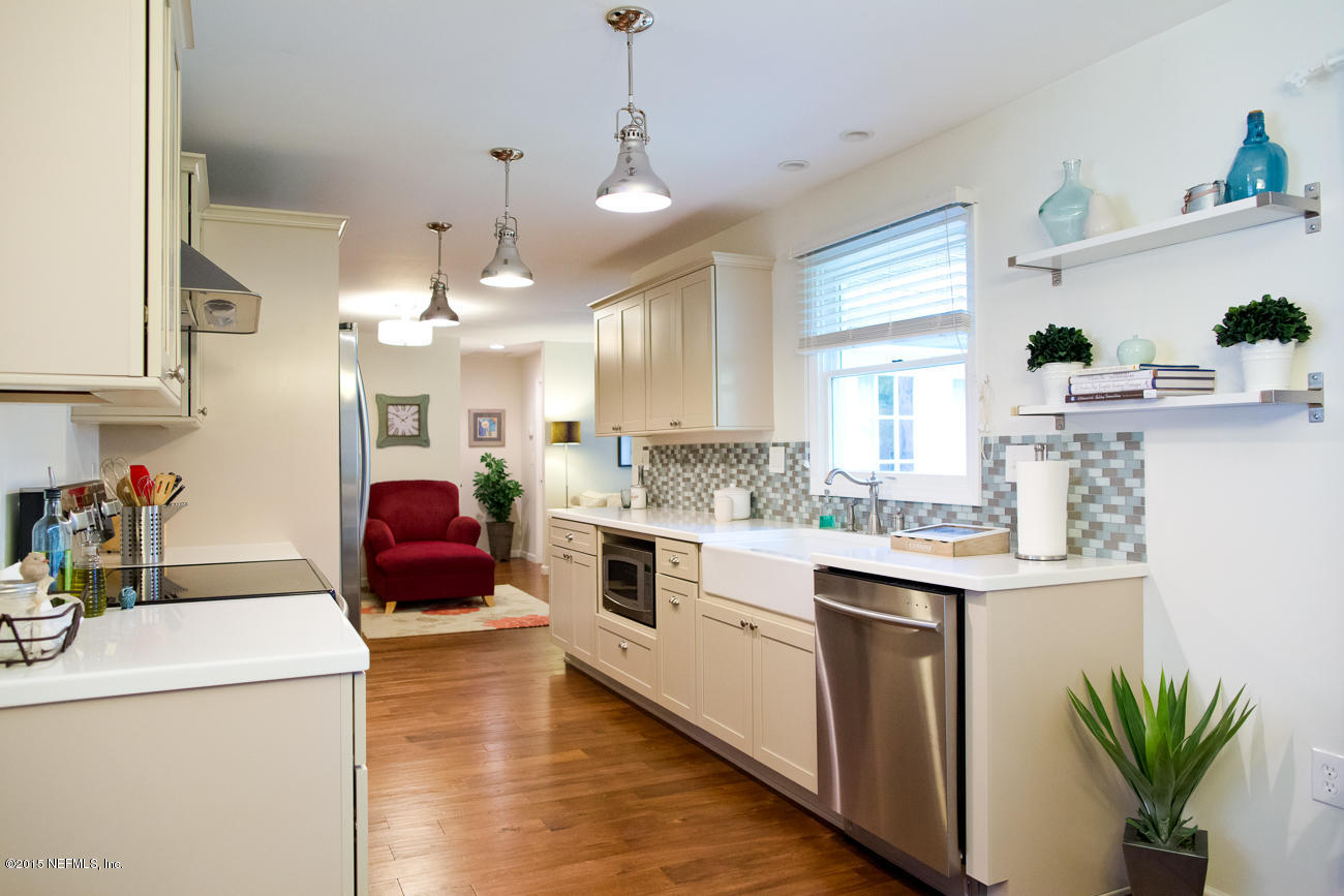 107 Saturn Road St. Augustine, FL 32086 - Photo 1 of 37 a kitchen with kitchen island a sink a stove and cabinets