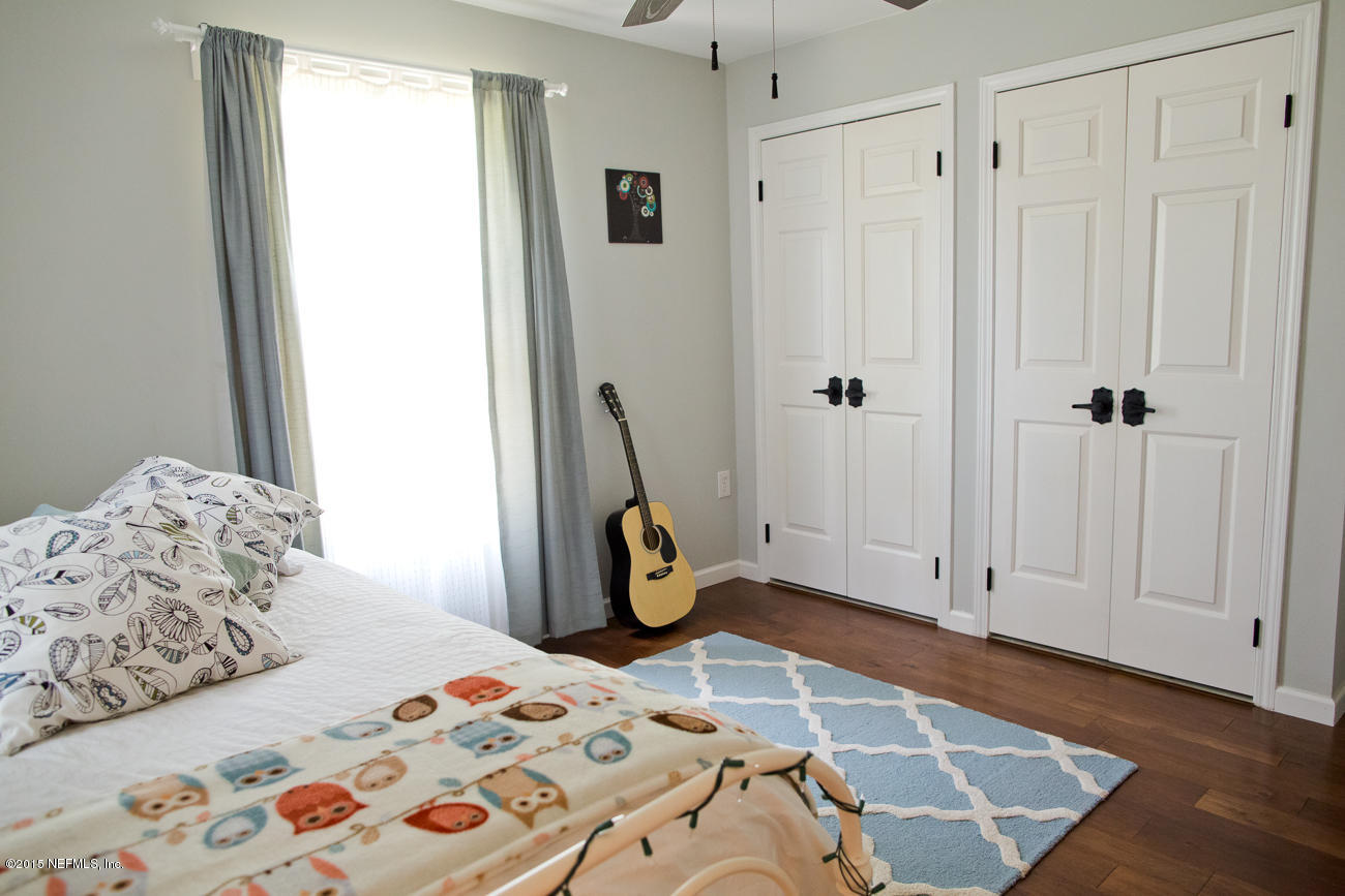 107 Saturn Road St. Augustine, FL 32086 - Photo 12 of 37 a bedroom with a bed and wooden floor