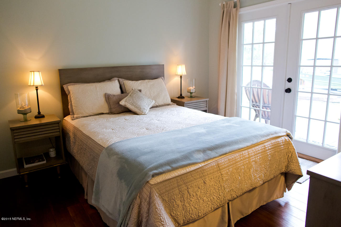 107 Saturn Road St. Augustine, FL 32086 - Photo 14 of 37 a bed sitting in a bedroom next to a window