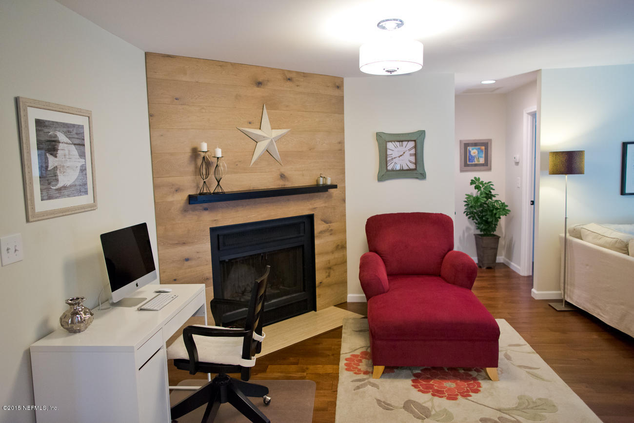 107 Saturn Road St. Augustine, FL 32086 - Photo 16 of 37 a living room with furniture a flat screen tv and a fireplace