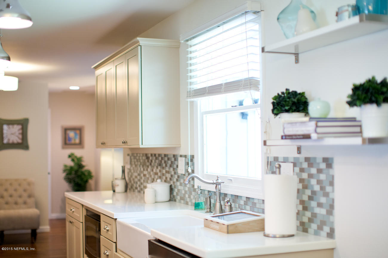 107 Saturn Road St. Augustine, FL 32086 - Photo 23 of 37 a bathroom with a granite countertop sink and a mirror
