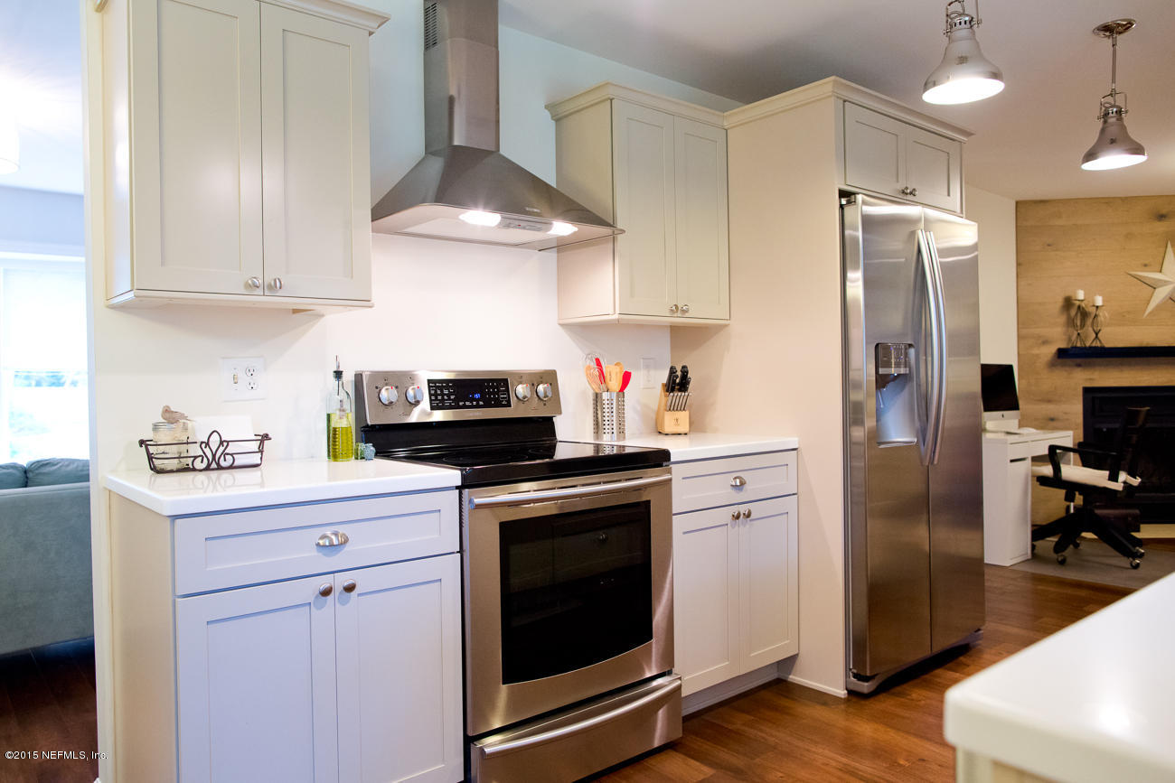 107 Saturn Road St. Augustine, FL 32086 - Photo 25 of 37 a kitchen with cabinets stainless steel appliances and wooden floor