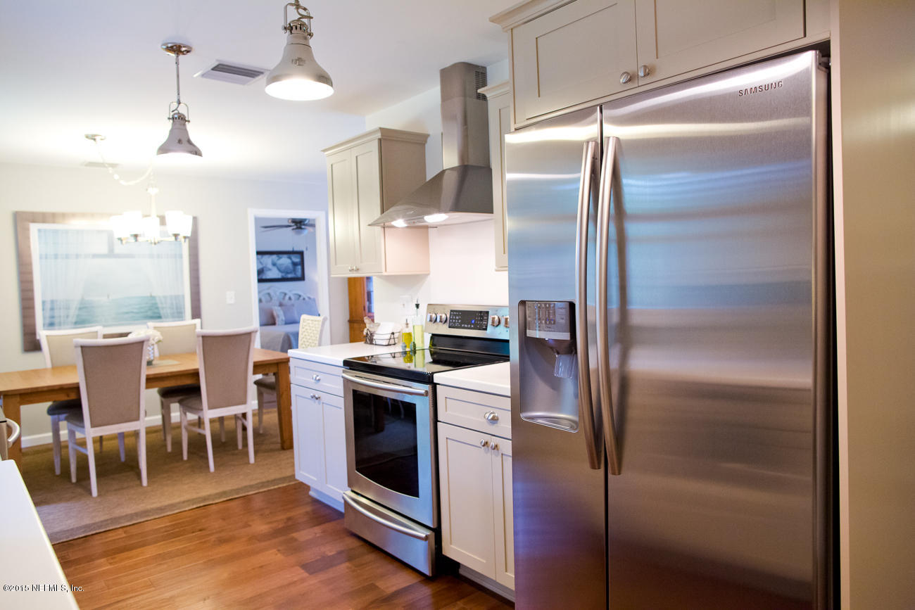 107 Saturn Road St. Augustine, FL 32086 - Photo 26 of 37 a kitchen with cabinets and stainless steel appliances