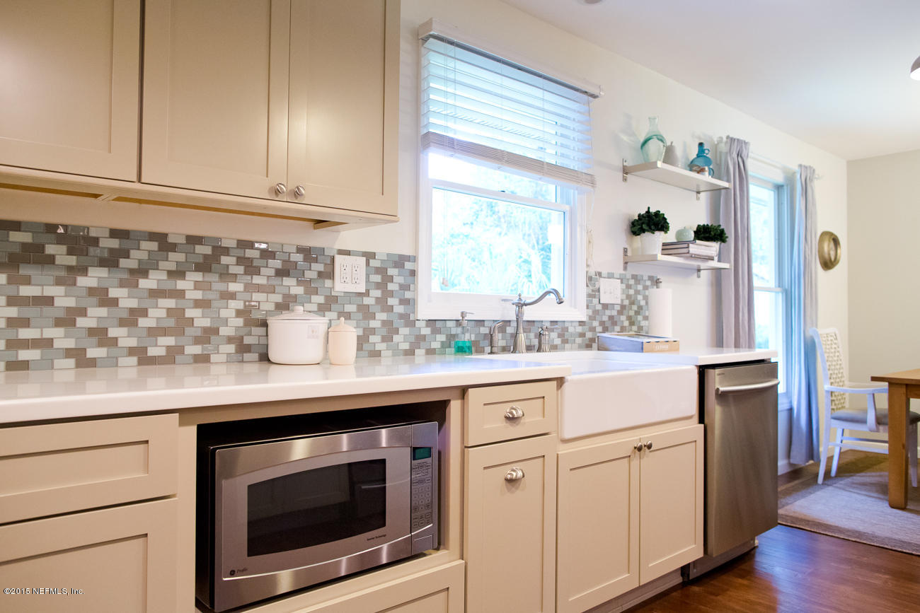 107 Saturn Road St. Augustine, FL 32086 - Photo 27 of 37 a kitchen with granite countertop white cabinets and white appliances
