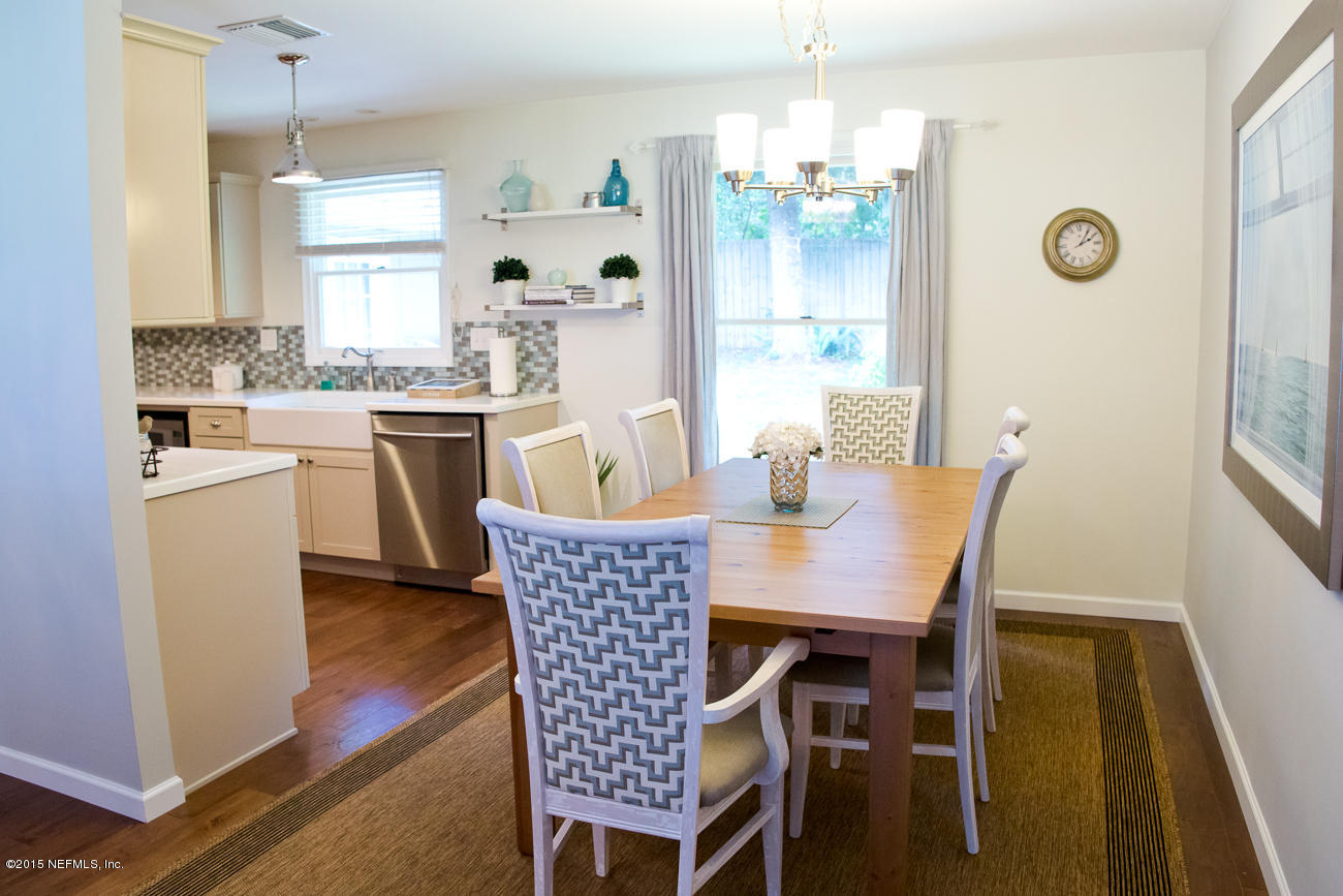 107 Saturn Road St. Augustine, FL 32086 - Photo 30 of 37 a dining room with furniture a chandelier and wooden floor