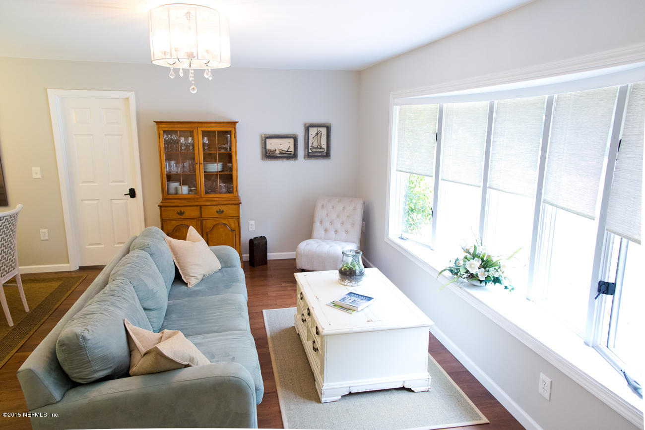 107 Saturn Road St. Augustine, FL 32086 - Photo 31 of 37 a living room with furniture a chandelier and a window