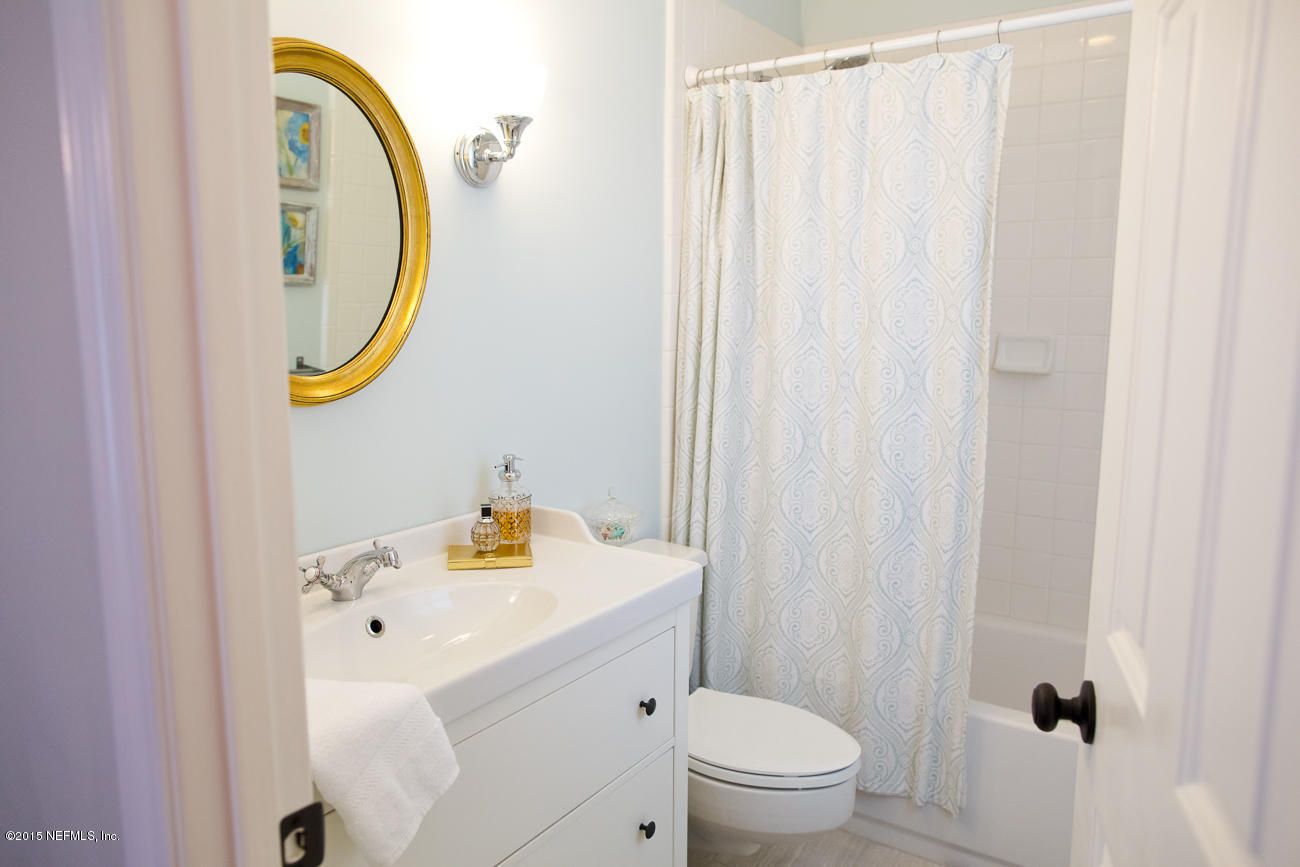 107 Saturn Road St. Augustine, FL 32086 - Photo 35 of 37 a bathroom with a sink a toilet and a mirror