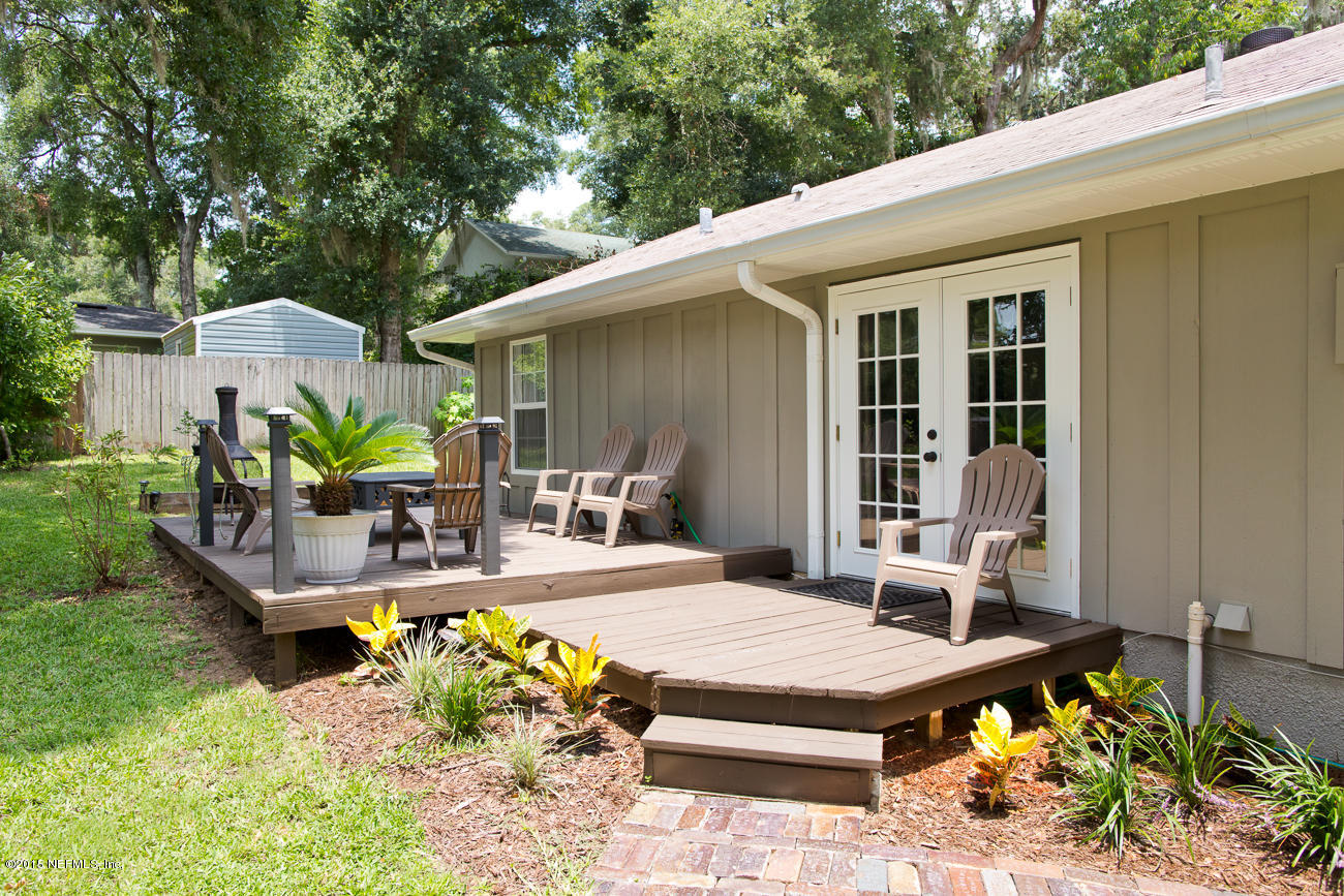107 Saturn Road St. Augustine, FL 32086 - Photo 4 of 37 a view of a patio with table and chairs potted plants with wooden floor