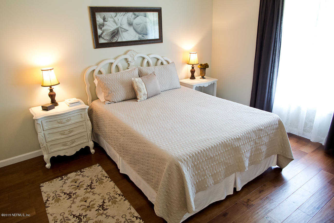 107 Saturn Road St. Augustine, FL 32086 - Photo 9 of 37 a bedroom with bed and wooden floor