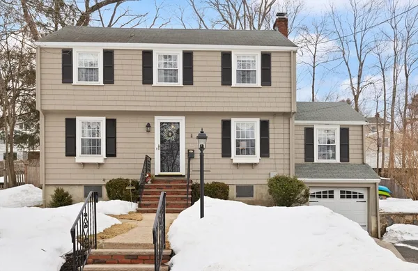 front view of a house with a bench