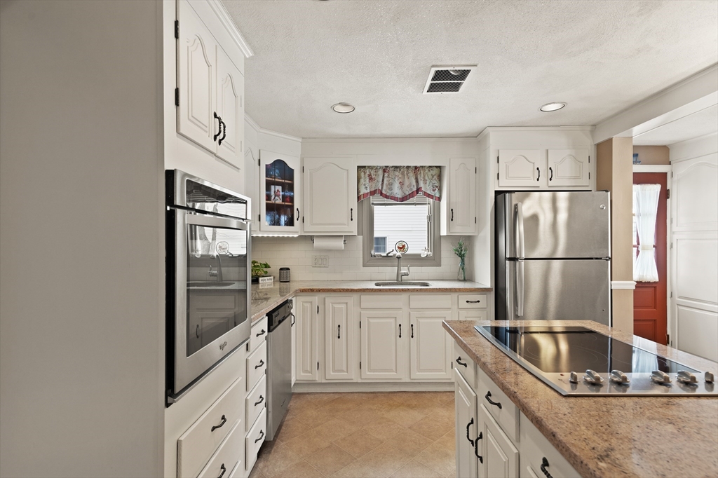 35 Longfellow Road Reading, MA 01867 - Photo 15 of 34 a kitchen with stainless steel appliances granite countertop a refrigerator sink and stove