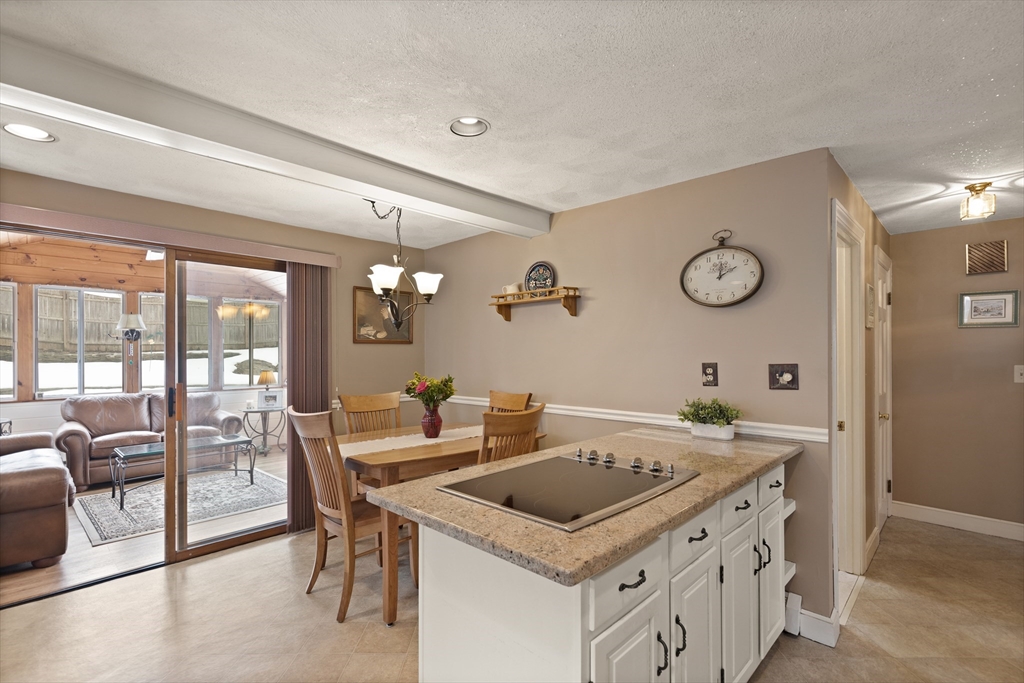 35 Longfellow Road Reading, MA 01867 - Photo 16 of 34 a kitchen that has a stove a table and chairs in it