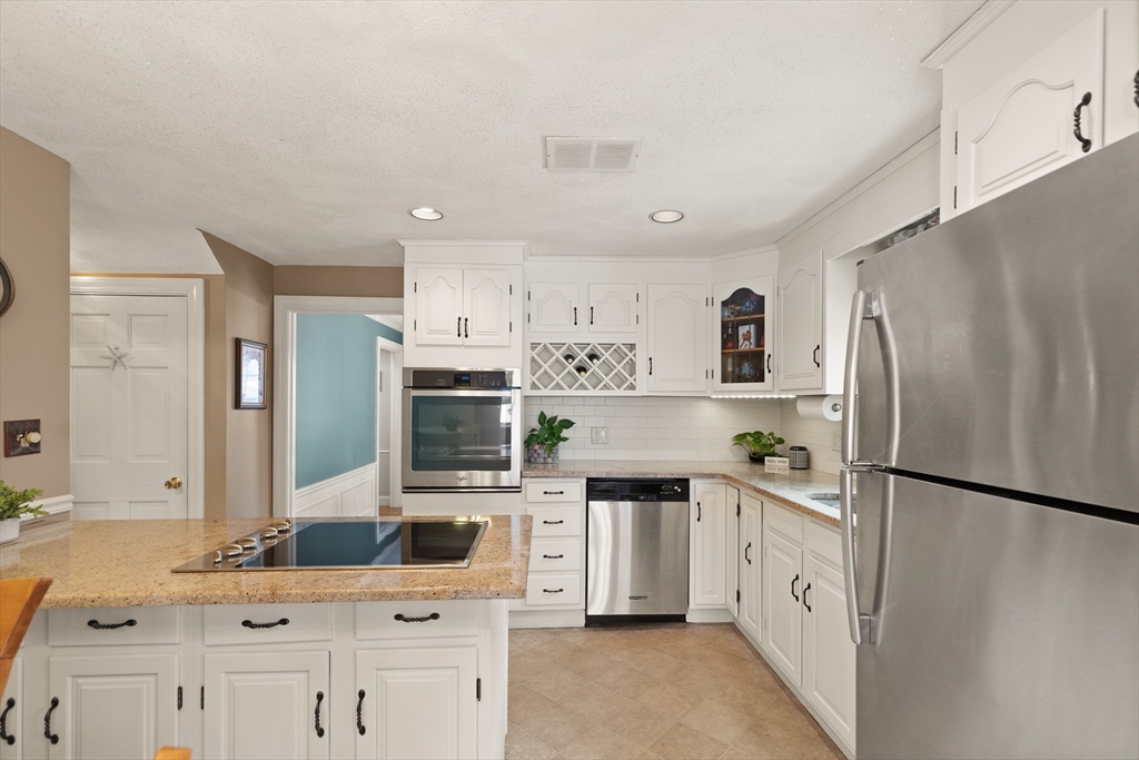 35 Longfellow Road Reading, MA 01867 - Photo 18 of 34 a kitchen with stainless steel appliances a refrigerator sink and microwave