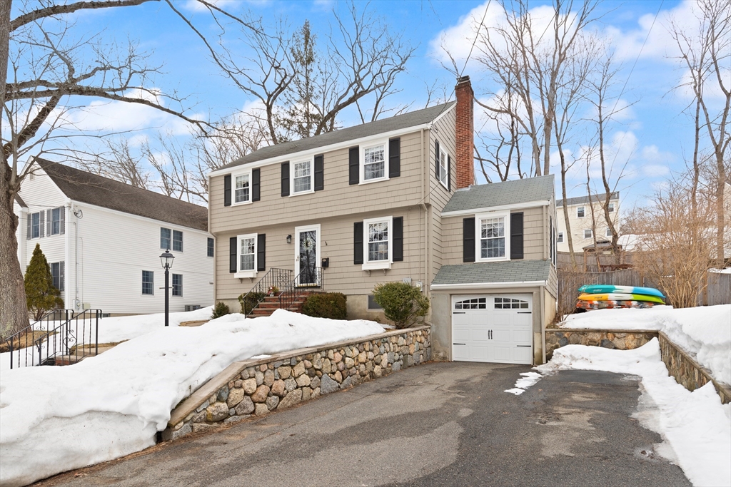 35 Longfellow Road Reading, MA 01867 - Photo 2 of 34 a view of a house with a yard covered in snow