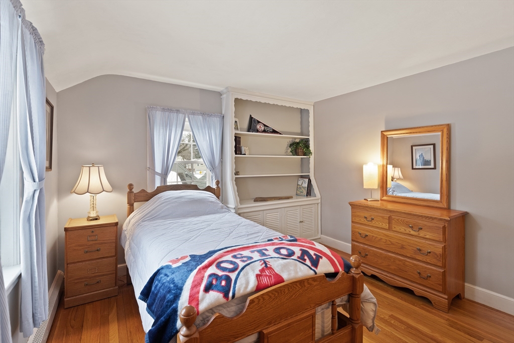 35 Longfellow Road Reading, MA 01867 - Photo 25 of 34 a bedroom with a bed and wooden floor