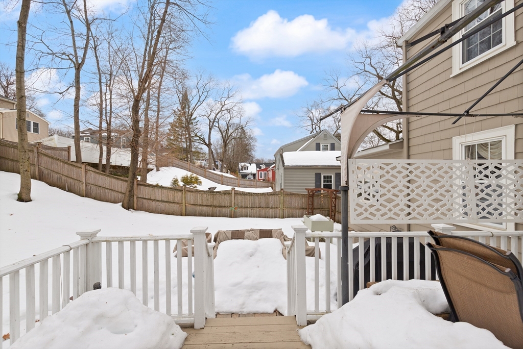 35 Longfellow Road Reading, MA 01867 - Photo 31 of 34 a view of a brick house with wooden fence