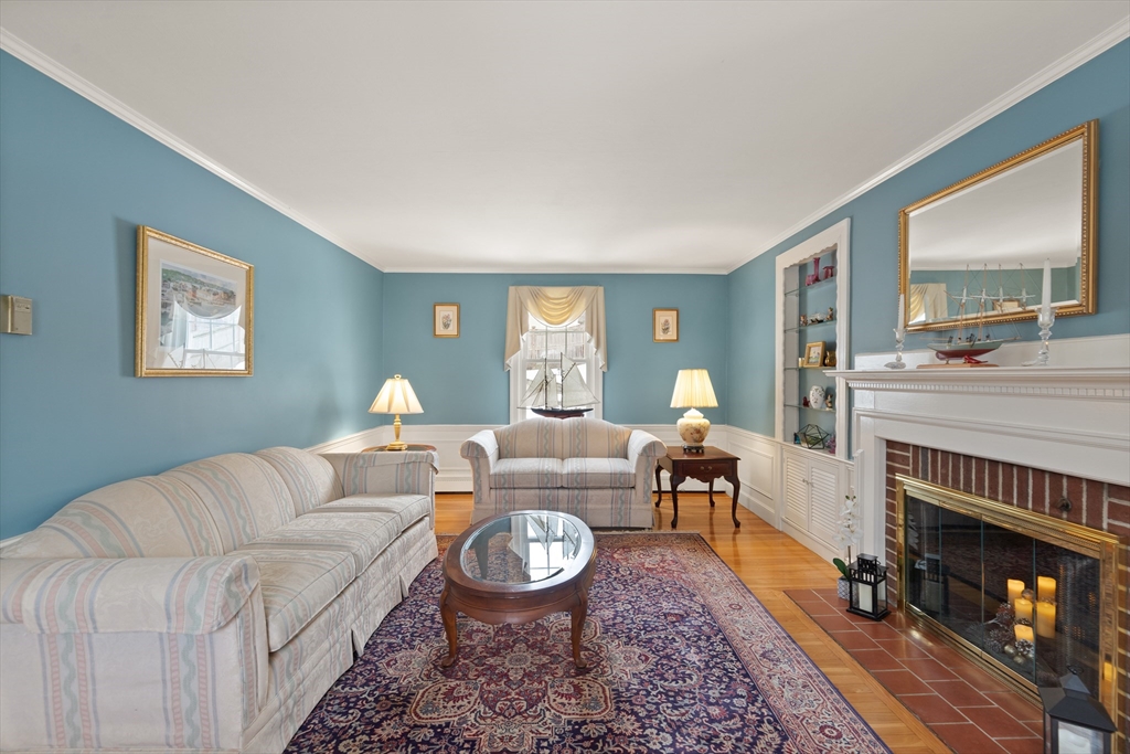 35 Longfellow Road Reading, MA 01867 - Photo 6 of 34 a living room with furniture a fireplace and a table
