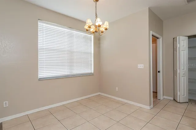 a view of a chandelier in a room and a window