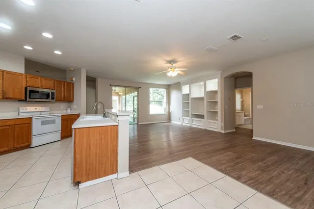 a open kitchen with cabinets and stainless steel appliances