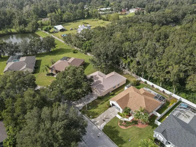 an aerial view of a house with a yard