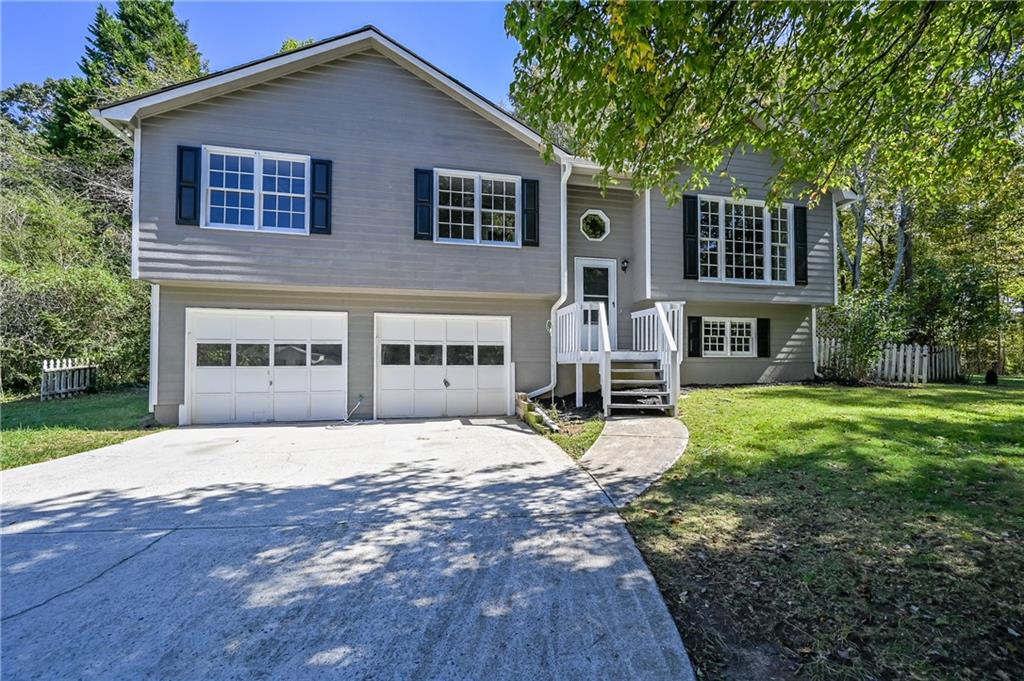 173 Ridge Run Drive Hiram, GA 30141 - Photo 1 of 1 a house that has a big yard and large trees