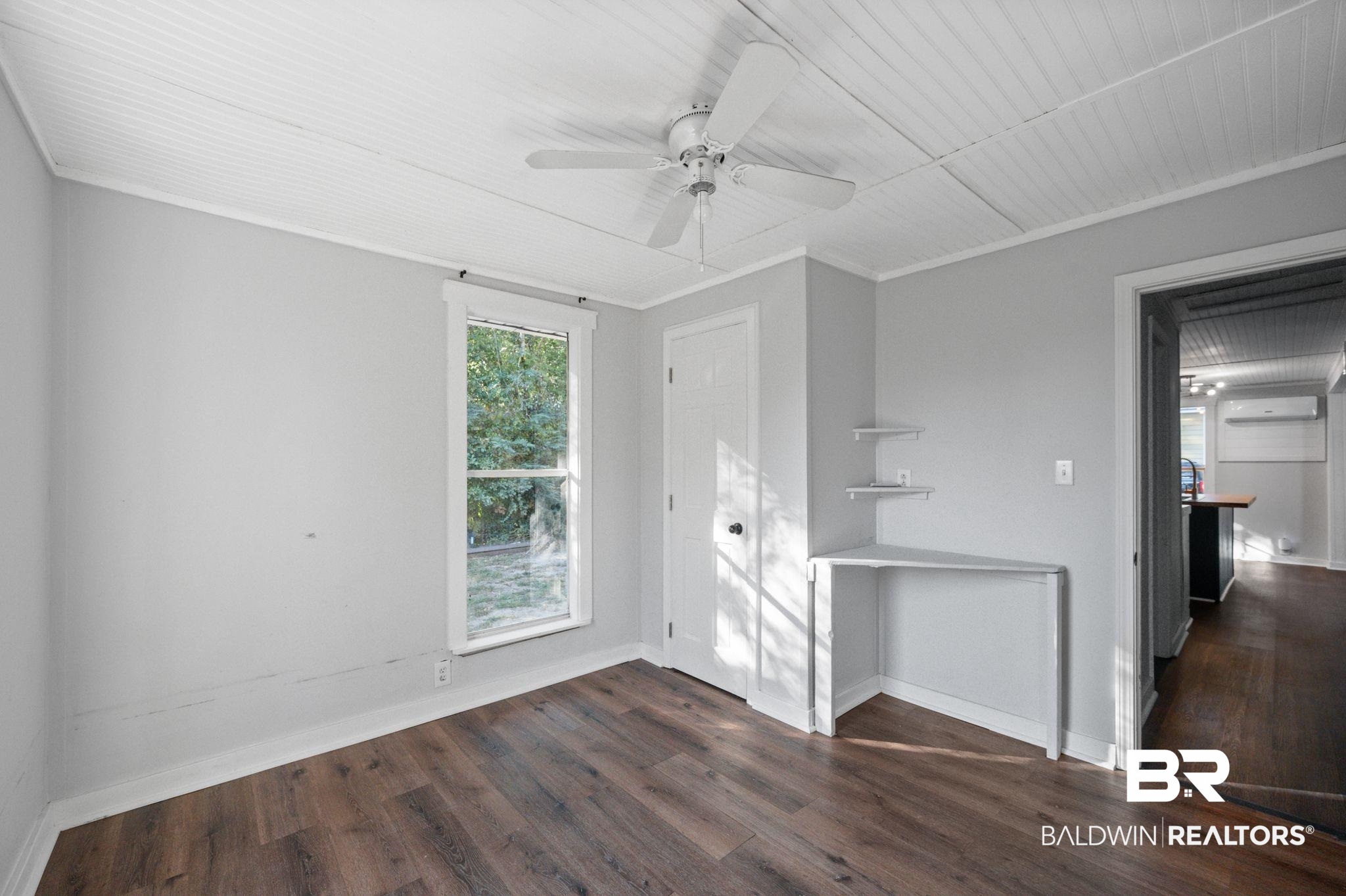503 North Holly Street Foley, AL 36535 - Photo 19 of 23 Unfurnished room with ceiling fan, a wall mounted AC, dark hardwood / wood-style flooring, and ornamental molding