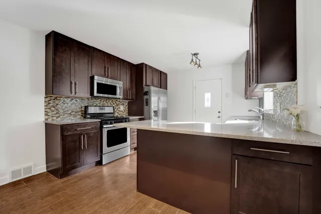 a kitchen with a sink cabinets and stainless steel appliances