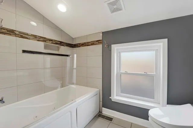 a bathroom with a bathtub and a shower