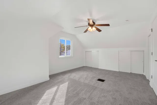 a view of room with a ceiling fan and window