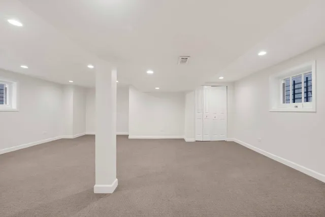 a view of an empty room with a kitchen