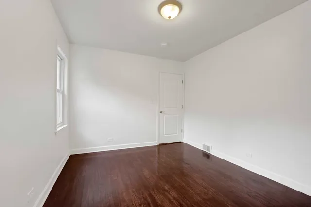 an empty room with wooden floor