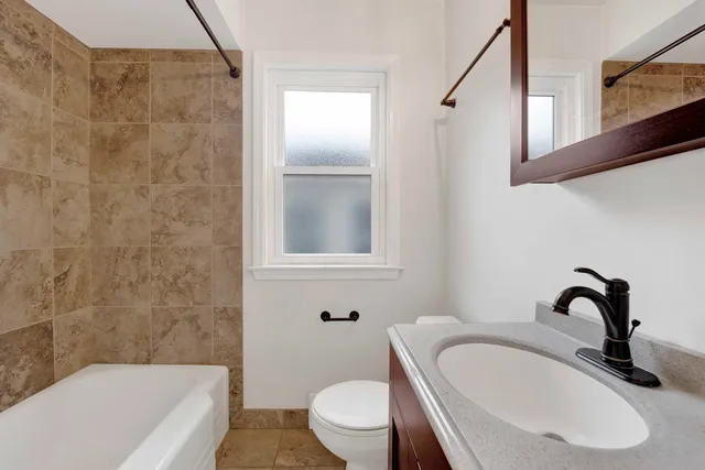 a bathroom with a sink a toilet and bathtub