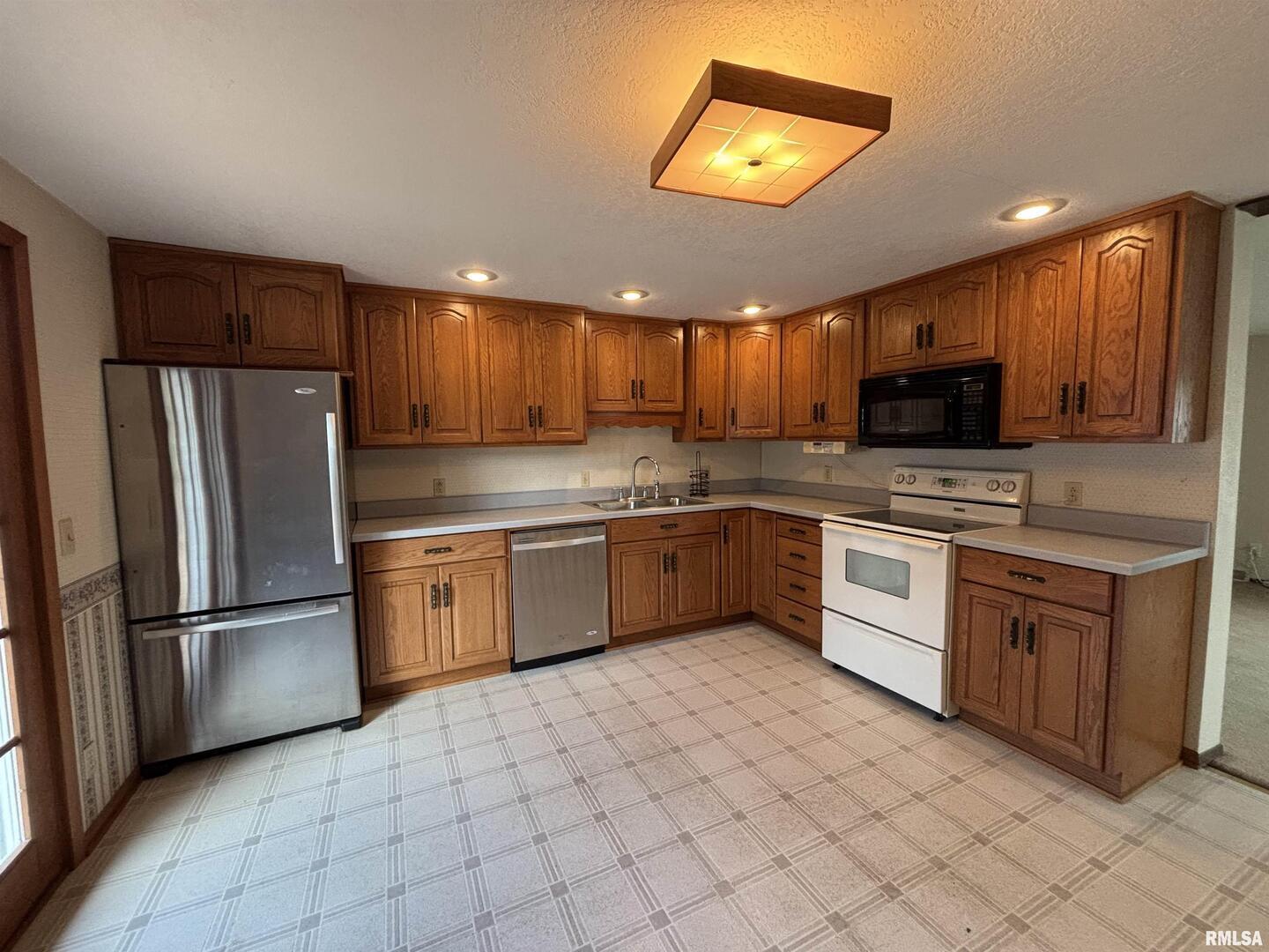 418 East Division Street Kewanee, IL 61443 - Photo 15 of 72 a kitchen with stainless steel appliances granite countertop a refrigerator sink and cabinets