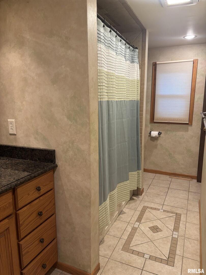418 East Division Street Kewanee, IL 61443 - Photo 28 of 72 a bathroom with a granite countertop sink and a mirror