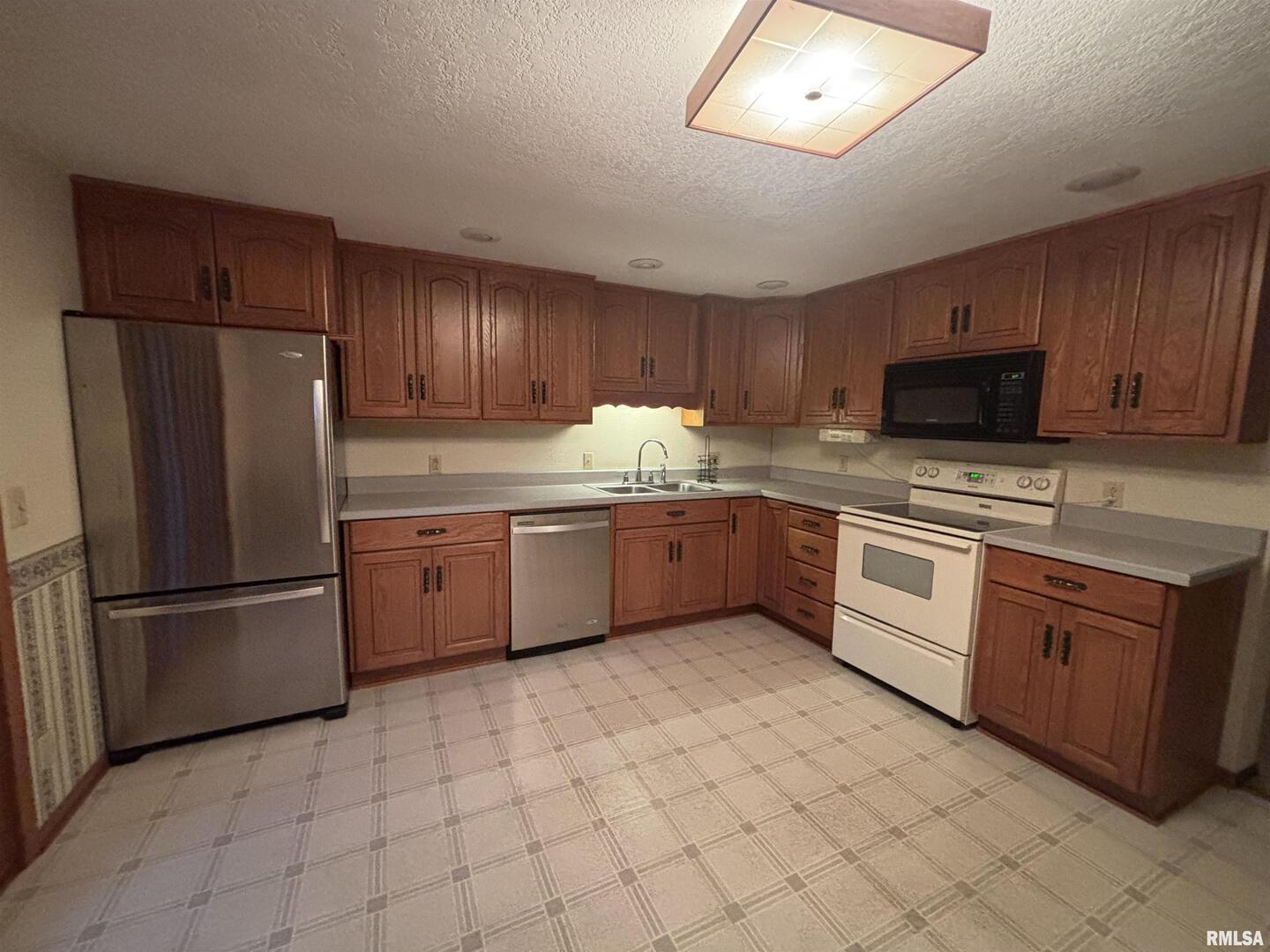 418 East Division Street Kewanee, IL 61443 - Photo 10 of 72 a kitchen with stainless steel appliances granite countertop a refrigerator sink and cabinets