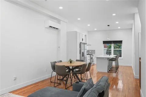a view of a dining room with furniture and wooden floor