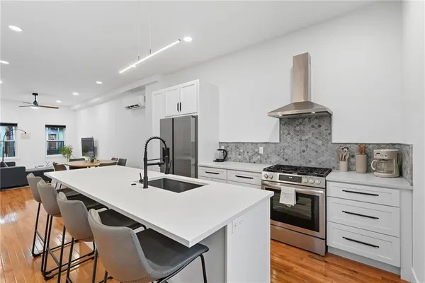a kitchen with a stove a sink and a refrigerator