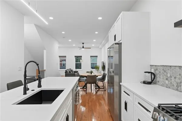 a kitchen with a refrigerator and a sink